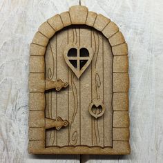 an image of a wooden door with a heart and cross cut out on it's side