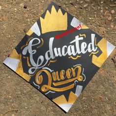 a black and gold graduation cap with the words, graduated queen on it's side