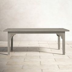 a gray table sitting on top of a white tiled floor