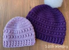 two crocheted beanies sitting on top of a wooden floor next to each other