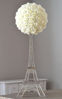 the eiffel tower is adorned with white roses for a special touch to someone's wedding