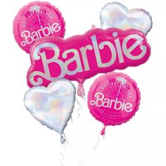 some pink and white balloons with the word barbie on them