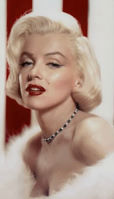 marilyn monroe in front of an american flag with her eyes closed and red lipstick on