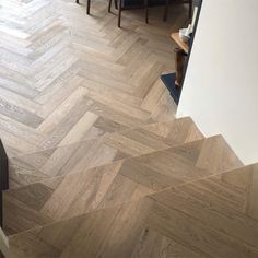 a living room with wood flooring and stairs