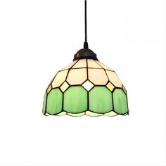 a green and white lamp hanging from a ceiling