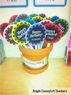 there are many happy birthday cupcakes in the pot on the desk with markers