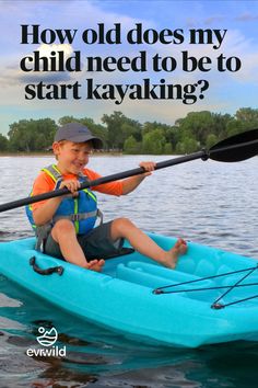 a young boy in a kayak with the caption how old does my child need to be to start kayaking?