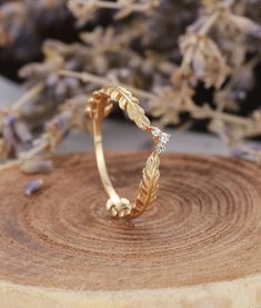 a close up of a gold ring with leaves on it