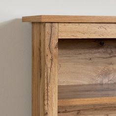 a close up of a wooden shelf against a wall