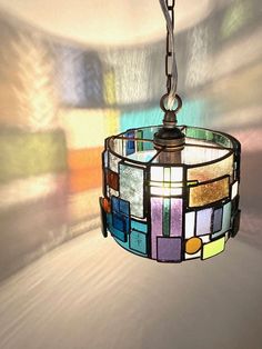 a stained glass lamp hanging from a ceiling