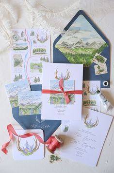 the wedding stationery is laid out with cards, envelopes, and other items