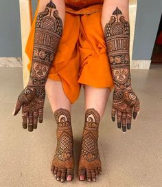 the legs and feet of a woman with henna tattoos