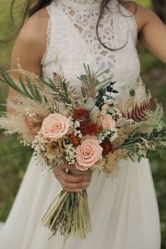 a woman holding a bouquet of flowers in her hands