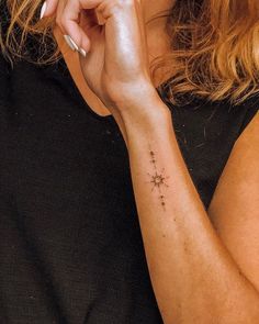 a woman with a small star tattoo on her arm