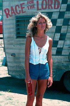 a woman standing in front of a trailer