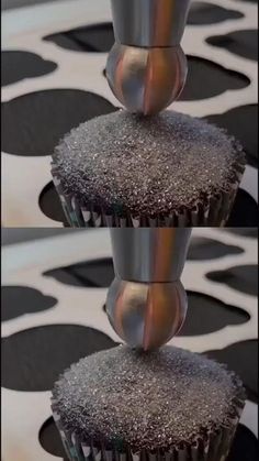 there are two cupcakes with silver frosting on them, and one is upside down