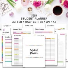 the student planner is set up on top of a table with flowers and other items