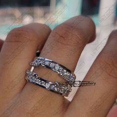 a woman's hand with a diamond ring on her left and an engagement band on her right