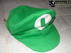 a green hat sitting on top of a tiled floor