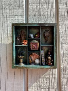 This 5x5 wooden Cabinet of Curiosities brings an exquisite Victorian touch to any home decor, ideal for lovers of dark academia and vintage collections. Handcrafted with a rich, hand painted finish, this display case has 7 small compartments, each showcasing unique trinkets, treasures, and oddities. Inspired by Victorian-era cabinets of curiosities, it's designed for those who appreciate a mysterious, old-world aesthetic. Perfect for gothic, steampunk, and Victorian-inspired interiors, this cabinet would fit beautifully. Great for curio collectors, antique decor enthusiasts, and those with a love for all things dark and whimsical. -Great for a gift -Perfect for small spaces -Ready to hang! Check out the rest of the shop https://www.etsy.com/shop/CipherArt and on social media, where we shar Wunderkammer Cabinet, Unique Trinkets, Cipher Art, Boho Style Kitchen, Found Object Sculpture, Object Sculpture, Vintage Collections, Shadow Box Art, Wooden Cabinet