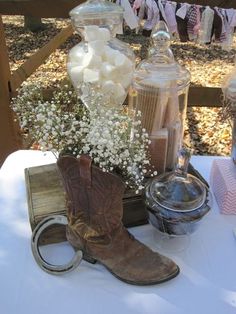 a cowboy boot with baby's breath in it sitting on top of a table