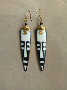 two black and white earrings with gold accents