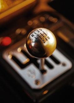 a close up view of a car's gear shift knob with the number plate and numbers on it