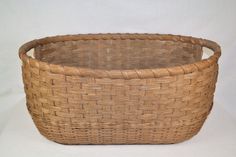 a large woven basket sitting on top of a white table