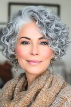 Cropped Curly Bob Hairstyle on a smiling woman in her 50s with gray hair. Colored Grey Hair, Gray Hair Styles For Women Over 60 Grey Curly, Grey Hair Perms, Permed Gray Hair Over 50, Short Curly Haircuts Older Women, Short Grey Curly Hair, Short Grey Hair Over 50 Modern Haircuts, Grey Curly Hair Over 50, Curly Gray Hair Over 50