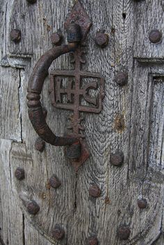 an old wooden door with a cross on it