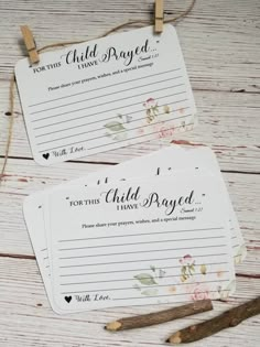 two children's prayer cards on clothes pegs with twine and paper clips