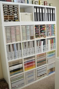 a white book shelf filled with lots of books