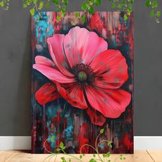 a painting of a pink flower on a wooden table