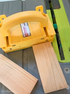 a piece of wood is being cut with a circular sawtoother and two pieces of plywood are laying next to it