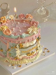 a birthday cake with pink frosting and flowers on it