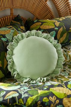 a close up of a bed with green pillows