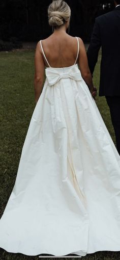 a bride and groom walking hand in hand