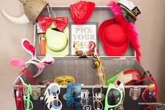 an open suitcase filled with lots of different types of hats and eyeglasses on display