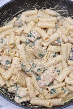 pasta with chicken and spinach in a skillet