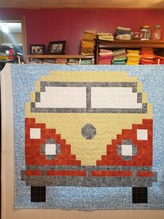 a quilted wall hanging with a vw bus on it