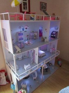 a doll house is shown with all the furniture and accessories in it's room