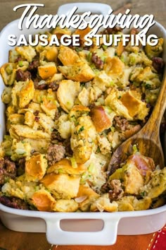 thanksgiving sausage stuffing in a white casserole dish with a wooden spoon on the side