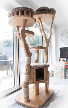 a cat tree house made out of wood