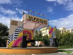 an outdoor stage set up in the middle of a park