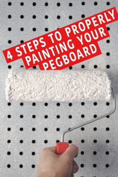 a hand holding a paint roller with the words 4 steps to properly painting your pegboard