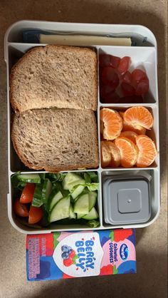 a lunch box with fruit, vegetables and bread