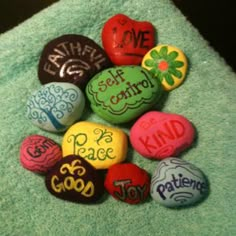 a pile of rocks that say faith, hope, love and peace on top of a towel