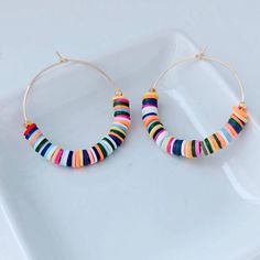 "These are weightless, trendy and so pretty! Gold plated hoops, weightless heishi beads and 2 gold textured beads make these earrings showstoppers! They measure approximately 2\" ." Trendy Rainbow Hoop Jewelry, Multicolor Small Hoop Beaded Earrings For Everyday, Everyday Multicolor Small Hoop Beaded Earrings, Everyday Multicolor Heishi Beads Jewelry, Trendy Small Hoop Rainbow Jewelry, Colorful Handmade Small Hoop Jewelry, Trendy Rainbow Small Hoop Jewelry, Trendy Multicolor Heishi Beads Jewelry, Handmade Colorful Hoop Jewelry