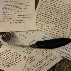 several papers with writing on them and an ink pen laying next to each other in the middle