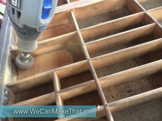 a driller is being used to make holes in the floor for wood planks